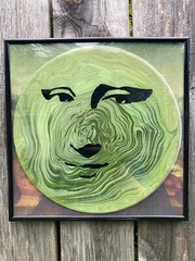 Acrylic Pour Painting resembling the Mona Lisa on a pop art style vinyl record