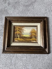 vintage framed oil painting depicting an autumnal landscape with trees Signed