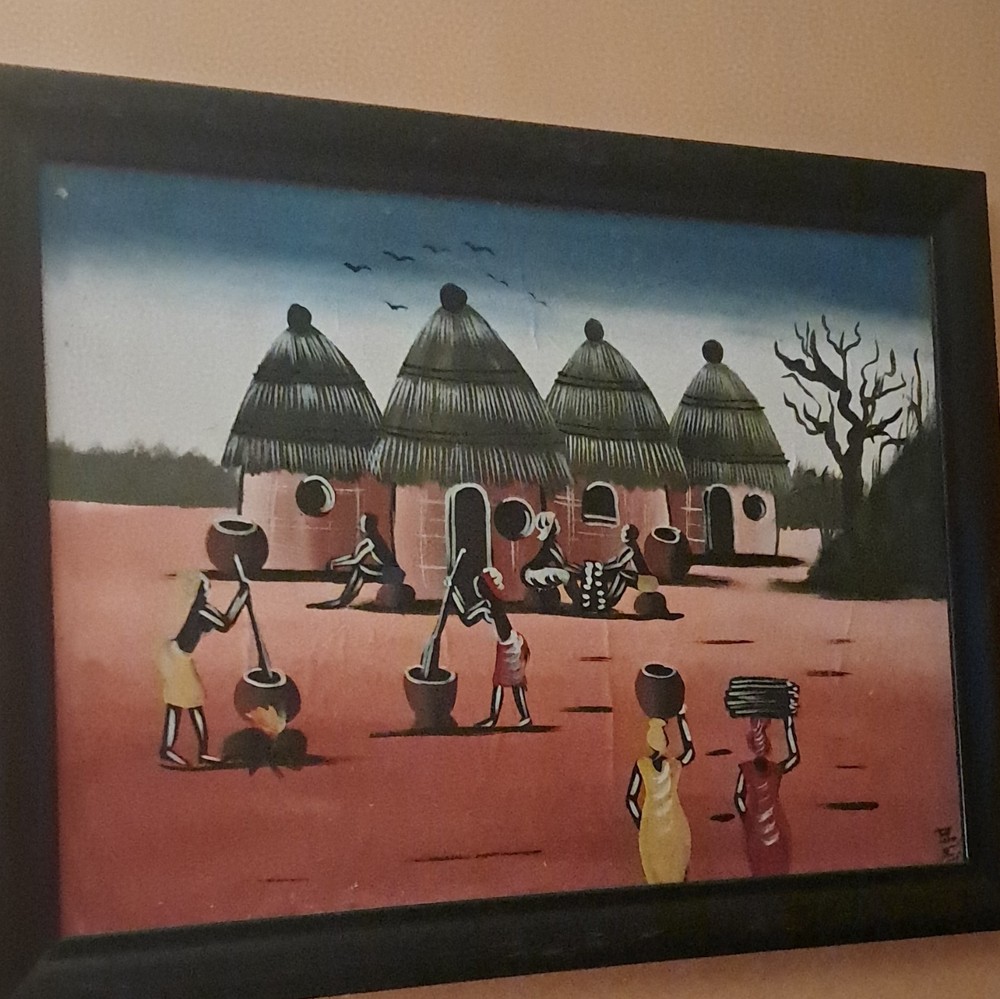 Folk Art Framed Village Scene Painting with Thatched Huts and People Figures