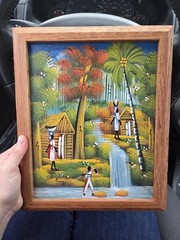 framed, vintage Haitian folk art painting. vibrant village scene. Signed