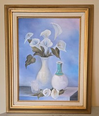 vintage framed artwork depicts white calla lilies in vases