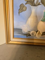 vintage framed artwork depicts white calla lilies in vases