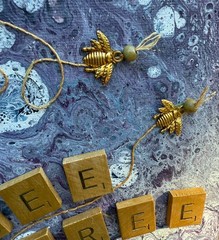 small paint pour art collage wall hanging, purple and gold with scrabble tiles