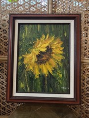 Vintage mpasto oil painting features a single vibrant yellow sunflower