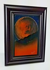Orange Moon Art Landscape comes with a dark frame by artist Jason Girard.