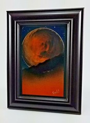 Orange Moon Art Landscape comes with a dark frame by artist Jason Girard.