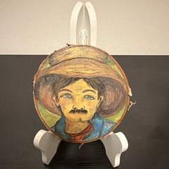 Charming man in a wide-brimmed straw hat, and a mustache. Painting on Wood Slice