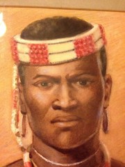 Watercolor by Hubert Whatley of African male in tribal dress, spear, and shield