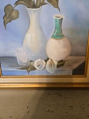 vintage framed artwork depicts white calla lilies in vases