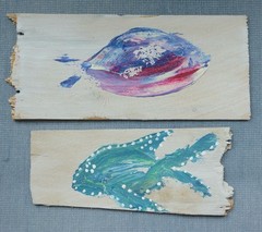 Two shingles from Cape Cod, Massachusetts that are painted with colorful fish!