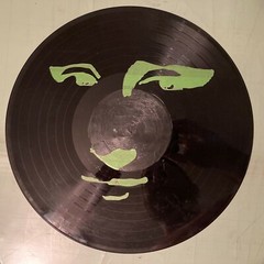 Acrylic Pour Painting resembling the Mona Lisa on a pop art style vinyl record