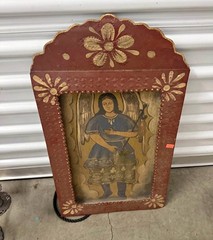 Folk art retablo painting of an angel, likely Archangel Raphael.
