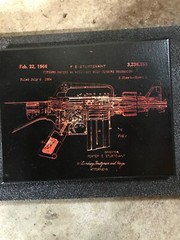 laser engraved painting of machine gun. 8×10 black red and white.