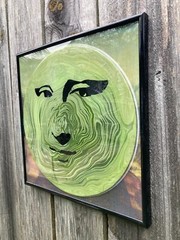Acrylic Pour Painting resembling the Mona Lisa on a pop art style vinyl record